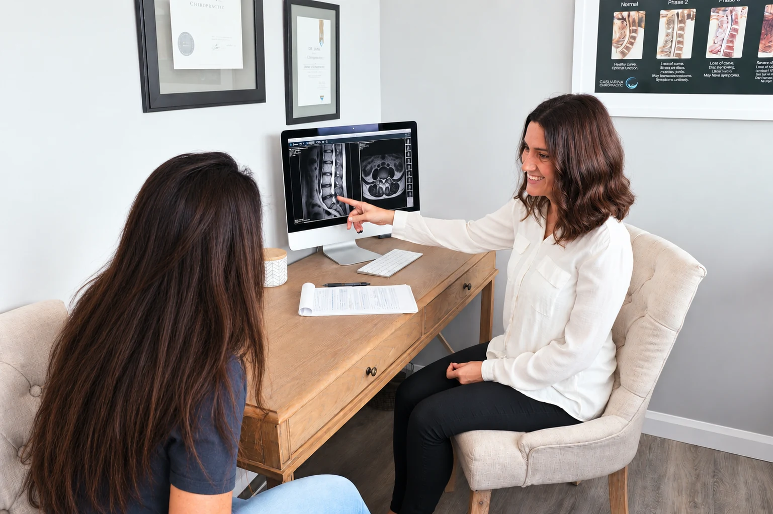 Jane and Kate reviewing lumbar spinal imaging at Casuarina Chiropractic.