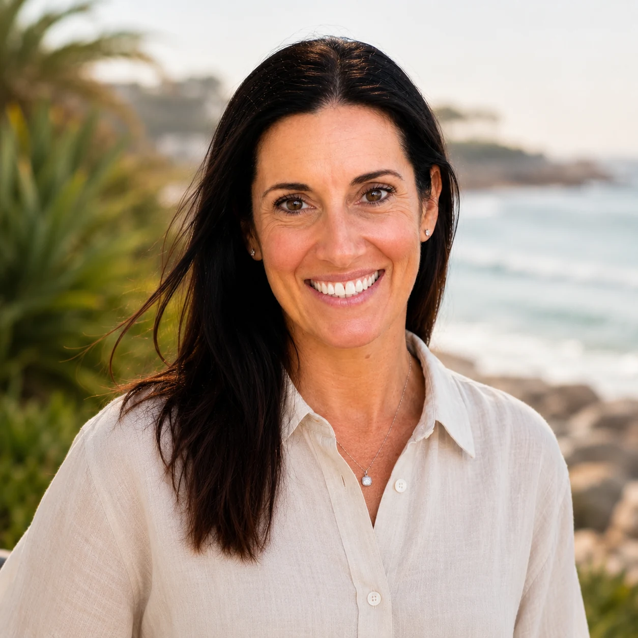 Dr Jane Hardy smiling by the coast.